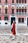 Young tourist in dress and coat on the streets of Venice — Stock Photo