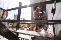 Construction site worker welding staircase at building site. — Stock Photo