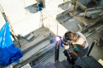High angle view of man welding on construction site. — Stock Photo