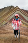 A young woman is standing on the famous Rainbow Mountain in Peru — Stock Photo