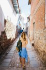 Молодая женщина идет по улице города Куско, Перу — стоковое фото