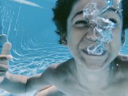 Підводний вид на дитину, що грає у басейні — стокове фото