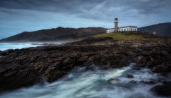 Lighthouse at the coast with stormy clouds. — Stock Photo
