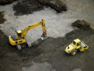 Excavator digging the road on nature background — Stock Photo