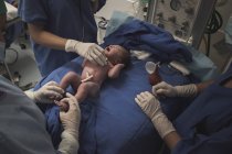 First moment of a newborn, labor in a hospital. After birth. — Stock Photo
