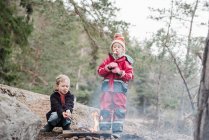 Bruder und Schwester kochen Marshmallows am Lagerfeuer in Schweden — Stockfoto