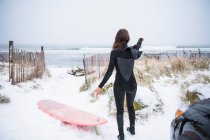 Жінка йде серфінгом в зимовий сніг — стокове фото