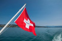 Drapeau suisse à l'arrière d'un bateau sur le lac de Zurich — Photo de stock