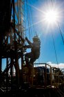 Drilling for natural gas against sun flare — Stock Photo