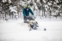 Man in helmet  snowmobiling in british columbia — Stock Photo