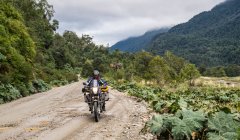 Man driving on a touring motorbike gravel road on  Carretera Austral — Stock Photo