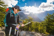 Woman hiking in the Andes mountain range towards Cerro Torre — Stock Photo