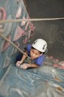 Young girl climbing at indoor climbing wall in England / UK — Stock Photo