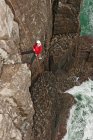Female climber rappelling of seacliff in Swanage / England — Stock Photo
