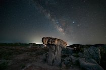 Milky way panorama above a mushroom-shaped rock — Stock Photo