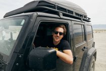 Young male off-roading in California desert. — Stock Photo