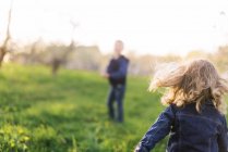 Two children on a walk in an orchard. — Stock Photo