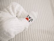 Close up of newborn baby legs wearing jumpsuit and socks — Stock Photo