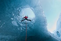 Young woman in climbing gear  ice climbing — Stock Photo