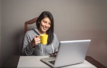 Pretty woman having a video conference at home — Stock Photo