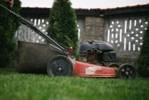 A closeup shot of a lawnmower in a garden on background, close up — Stock Photo