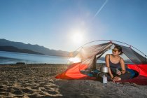 Woman relaxing at camp at the Nahuel Huapi Lake in Patagonia — Stock Photo