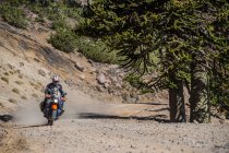 Man on touring motorbikes driving on gravel road in Argentina — Stock Photo