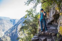 Woman looking down from Inca Trail path close to Machu Picchu, — Stock Photo