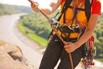 Close up of woman rappelling of cliff in south Wales — Stock Photo