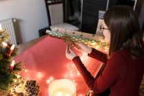 Millennial woman with Christmas decorations in a festive atmosphere — Stock Photo