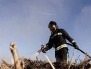 Firefighters spray water to wildfire. — Stock Photo