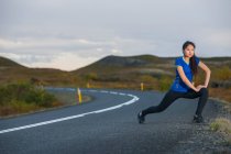 Beautiful woman stretching during work out in rural area in Iceland — Stock Photo