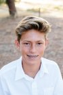 Retrato de un guapo adolescente chico con marrón ojos y frenos - foto de stock