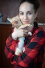 Woman holding a small dog — Stock Photo