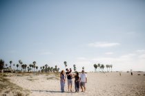 Family of Five Walking on Beach — Stock Photo