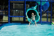 Kid coming out of waterslide — Stock Photo