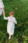 Portrait of a little girl exploring holding her mothers hand — Stock Photo