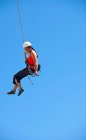 Woman rappelling from rock face in Swanage / UK — Stock Photo