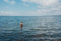 Tween boy wading in Lake Ontario on a summer day. — Stock Photo