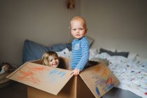 Brothers playing and drawing in a box during lockdown — Stock Photo