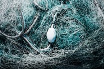 Fishermans nets and buoy tangled together — Stock Photo