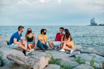 Group of young people at sunset in Barcleona Beach — Stock Photo