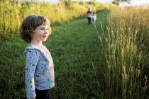 Kleines Mädchen mit verschmiertem und unordentlichem Mund steht glücklich auf einem Feld — Stockfoto