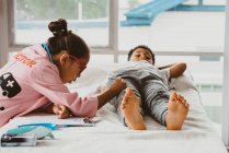 Childhood roleplay as doctor and patient — Stock Photo