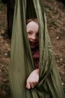 Young girl wrapped up in hammock outside — Stock Photo