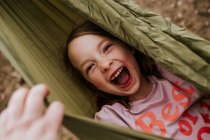 Young girl wrapped up in hammock outside — Stock Photo