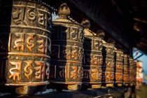 Buddhist prayer wheels at a temple in Kathmandu, Nepal. — Stock Photo
