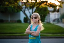 Портрет блондинки-молодої дівчини, що перетинає руки з сонцезахисними окулярами на — стокове фото