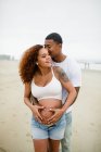 Mixed Race Couple Embracing and Posing on Beach — Stock Photo