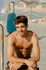 Young handsome men portrait exercising at the beach — Stock Photo